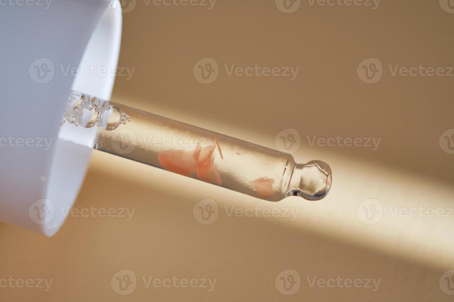 Pipette with serum on beige background with sunlight. photo