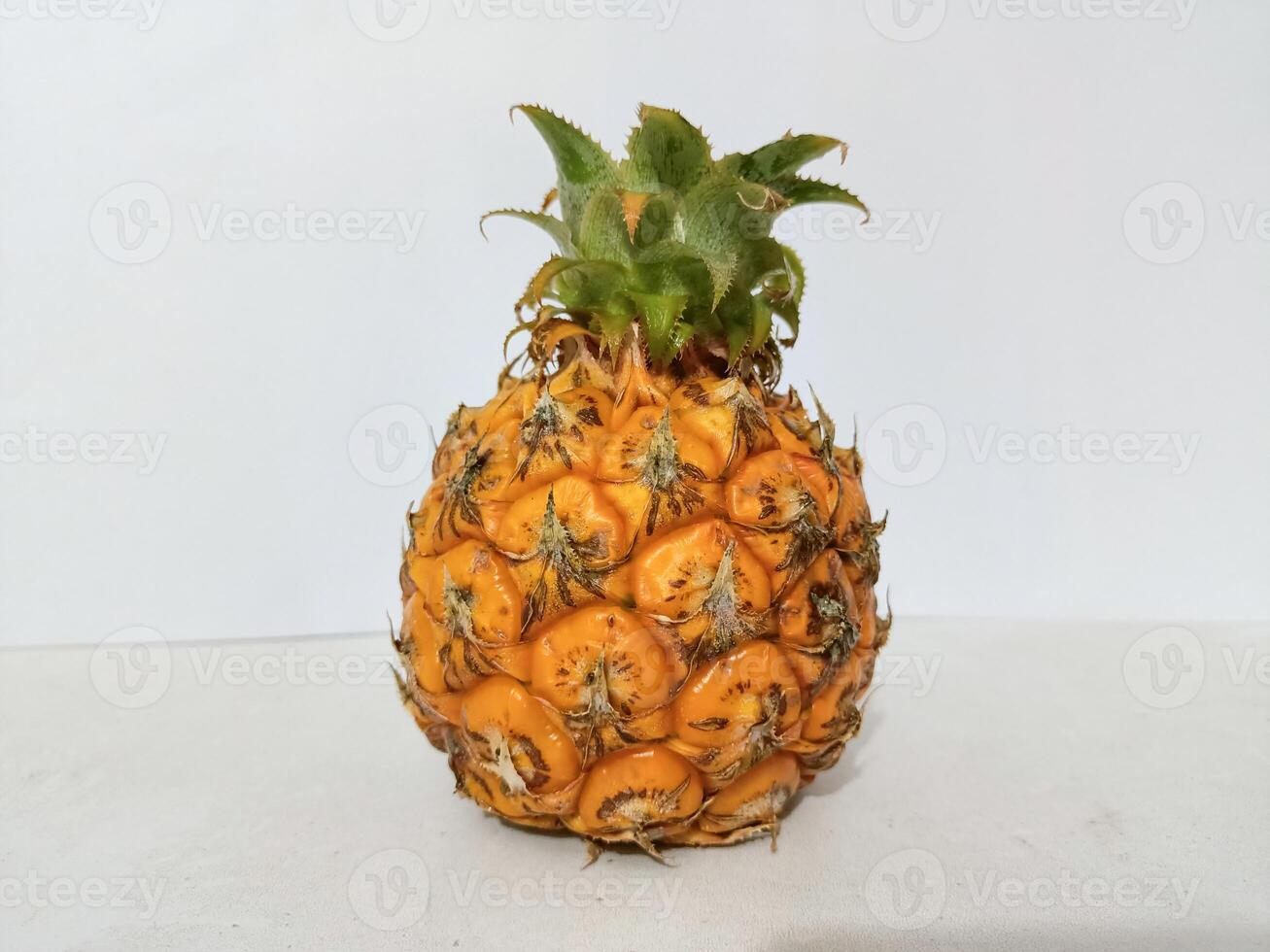 Exotic Ripe Pineapple with Unique Shape Close-Up on White Background photo