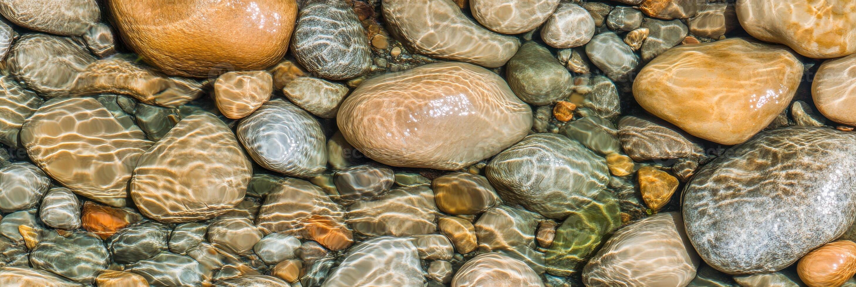 Riverbed stones under sunlight creating mesmerizing water patterns in nature photo
