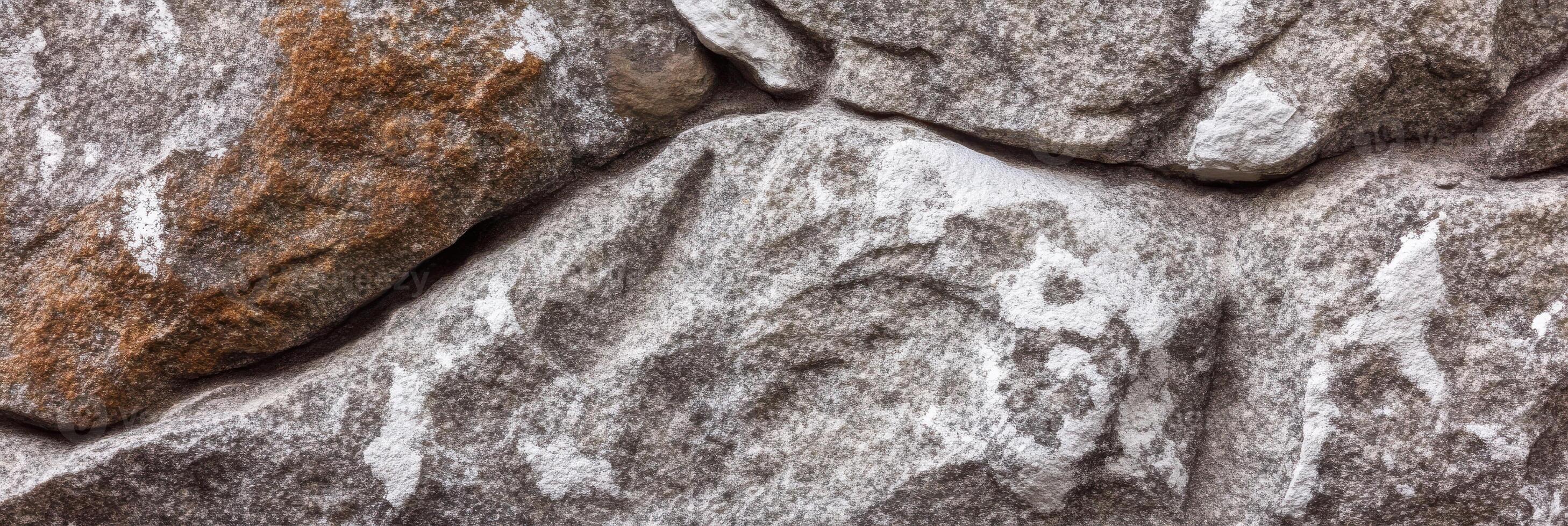 Close-up view of natural textured stone wall surface background photo
