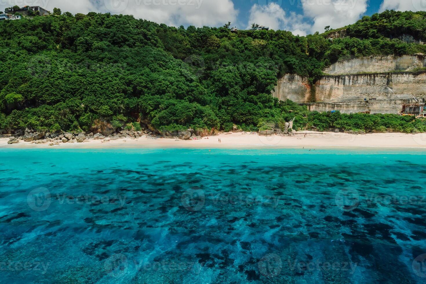 Aerial view of tropical coastline with beach, rocks and turquoise ocean photo