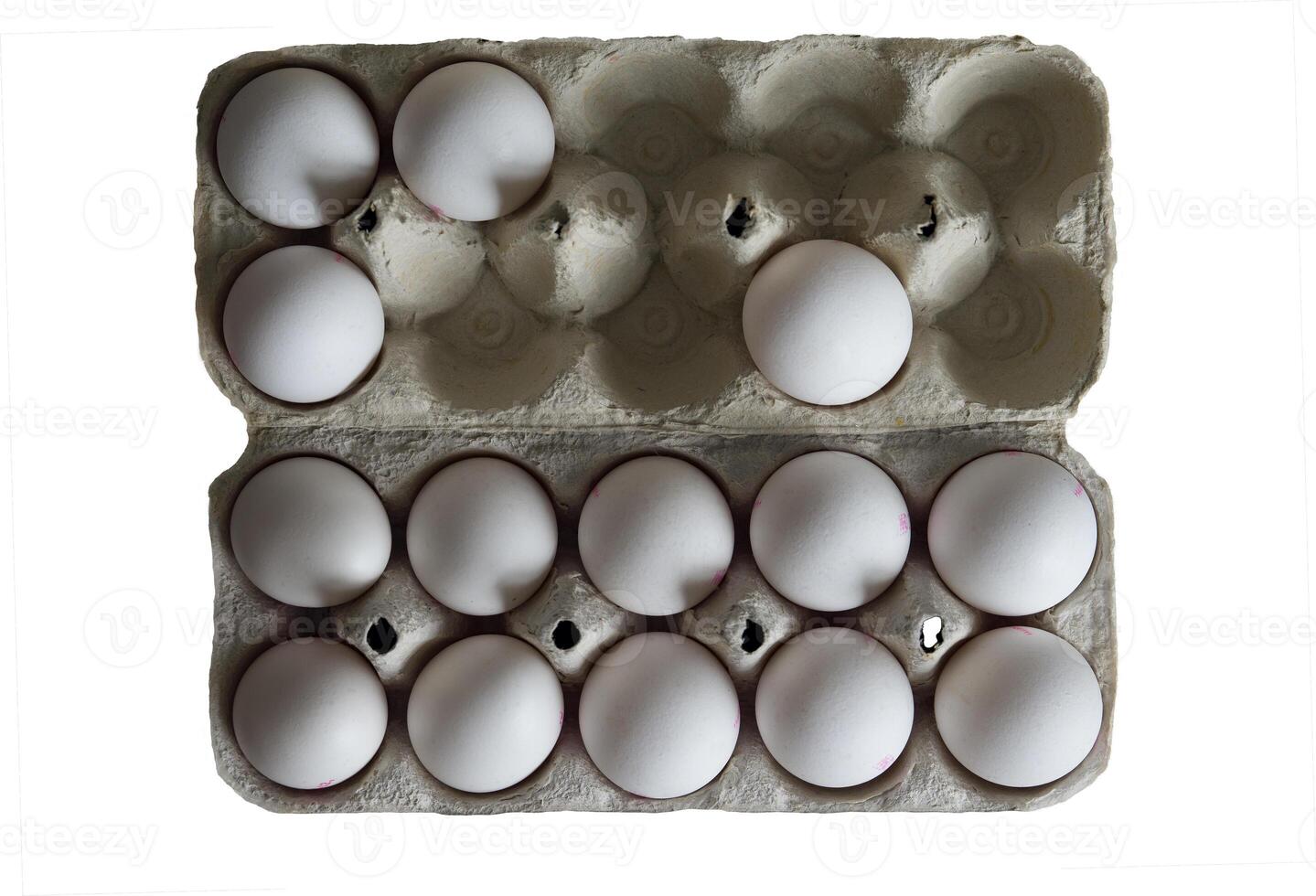 Tray with chicken eggs isolated on a white background. An open paper tray with chicken eggs that holds 14 white eggs. photo
