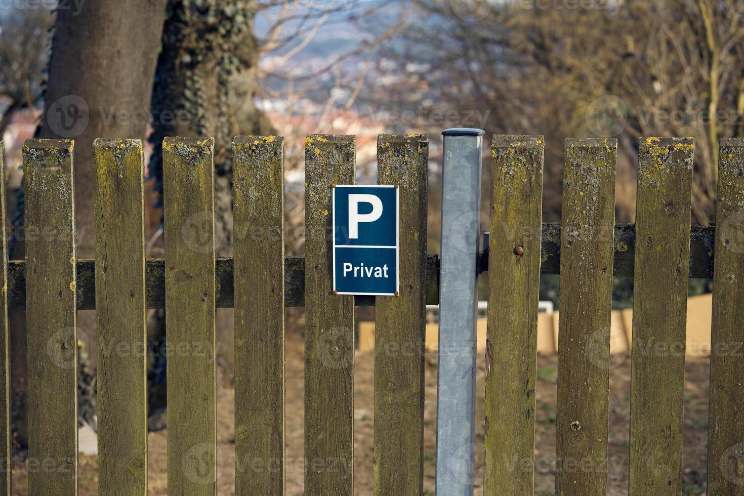 Aged wooden fence with a Privat sign. Ideal for illustrating topics related to security, privacy, and country style photo