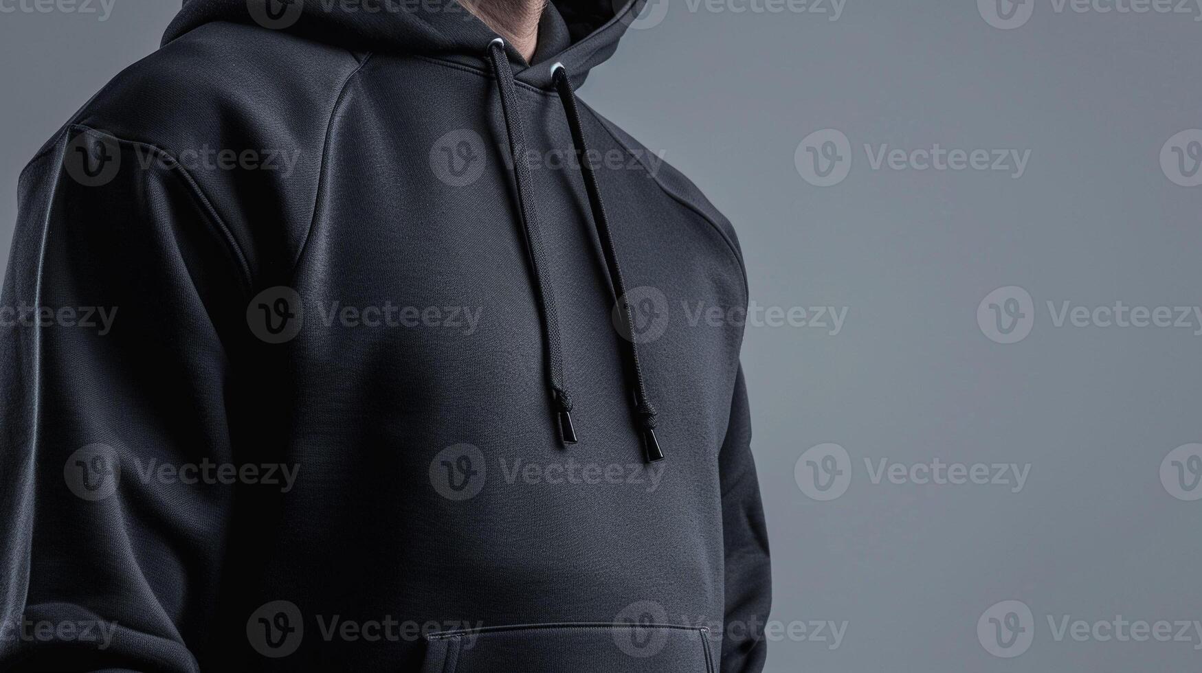 A man in a black hoodie and jeans photo