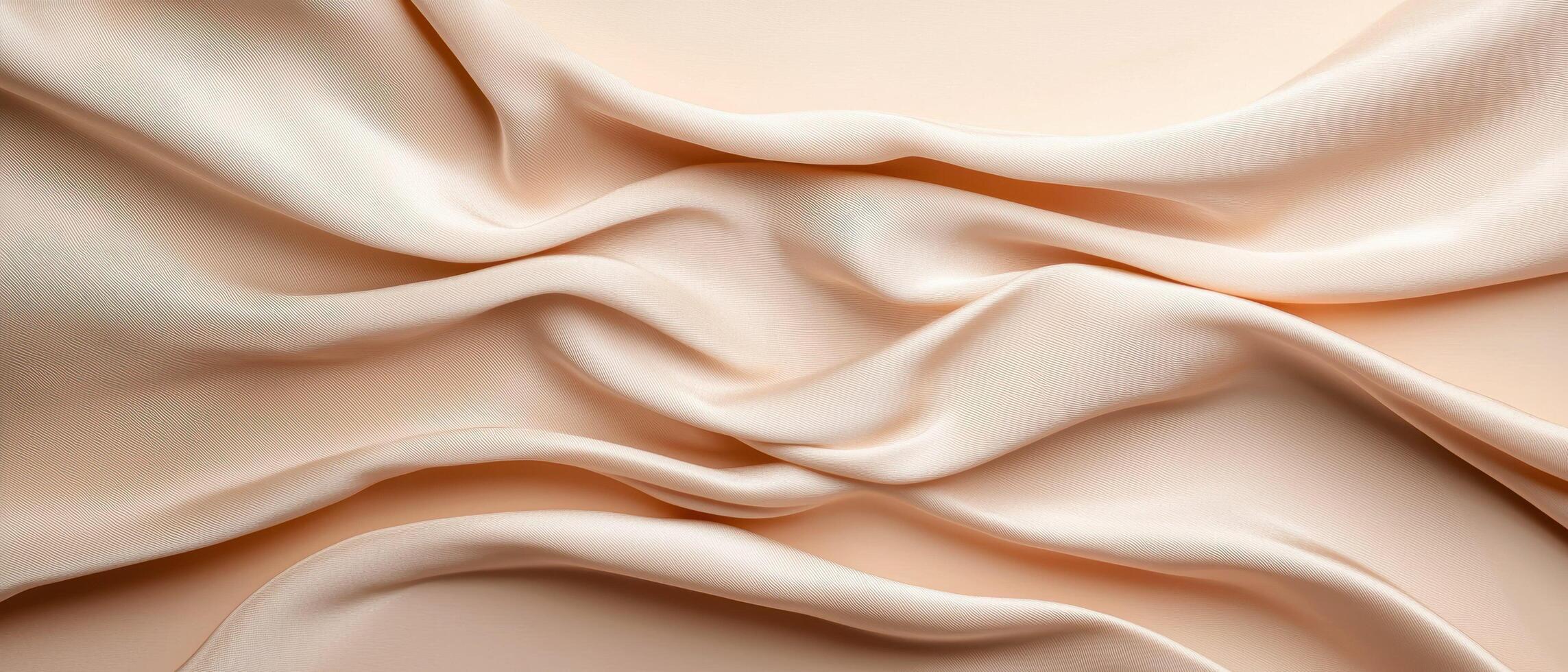 Soft beige fabric with elegant folds and gentle drapery. The smooth texture and flowing curves create a luxurious and delicate aesthetic, perfect for backgrounds and textile designs. photo