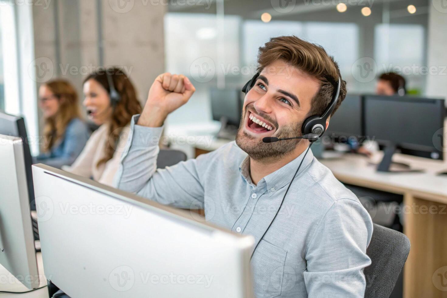 Happy customer service representative celebrating success in modern office environment, showcasing teamwork and support photo