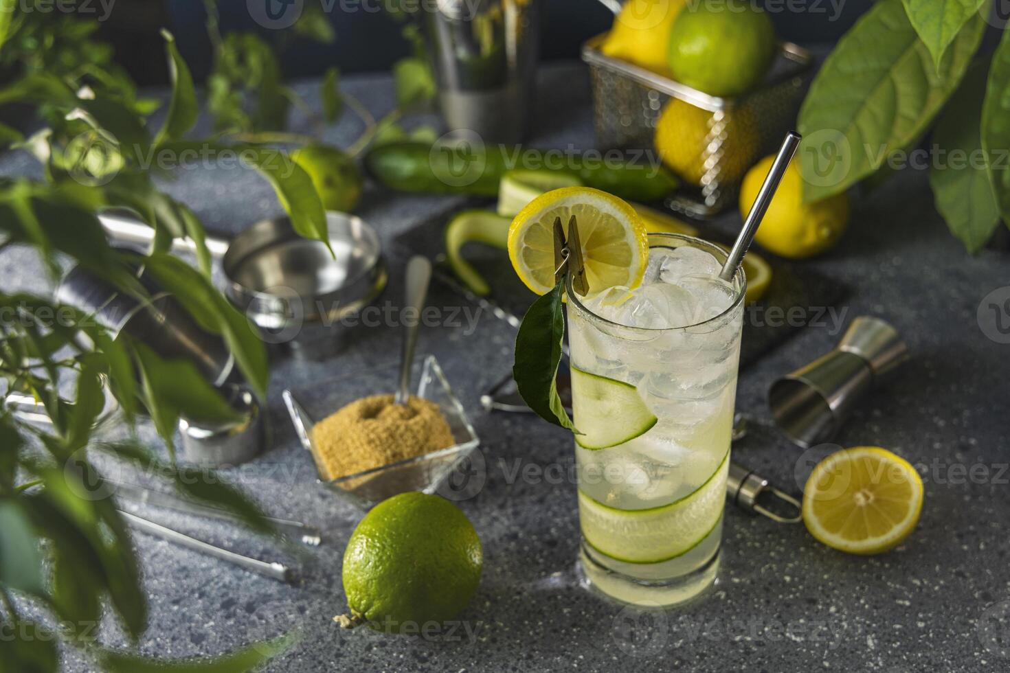 Bartender preparing refreshing cucumber lemonade cocktail with metal straw photo