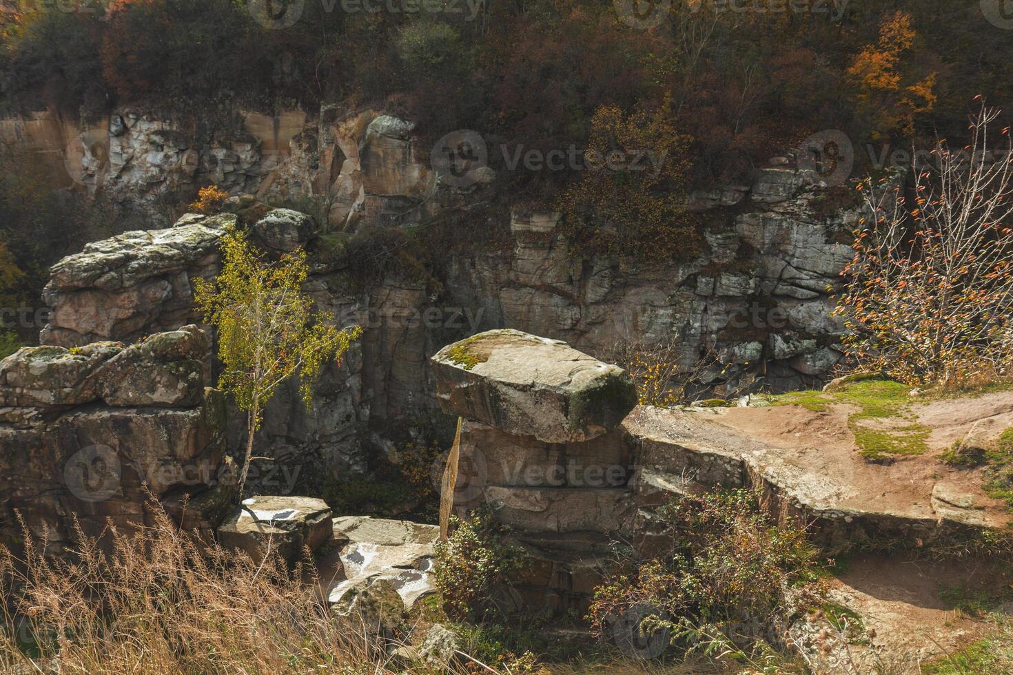 Rocky landscape showing stone quarry in autumn forest photo