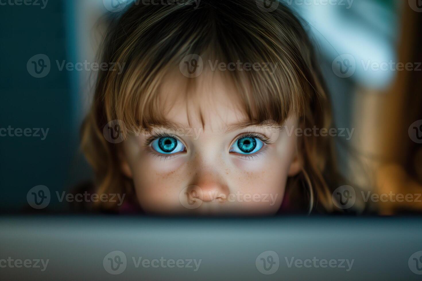 Close-up image of a young girl looking at a screen, used in research to quantify gender bias in advertising. photo