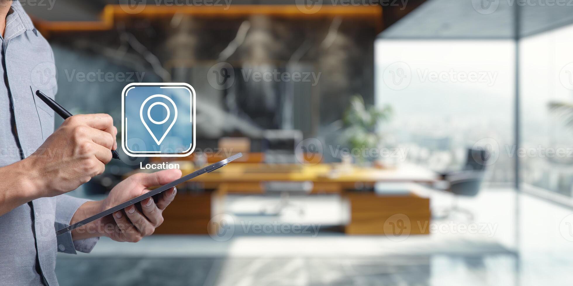Hand Holding Tablet with Pin Icon in Modern Office Environment photo