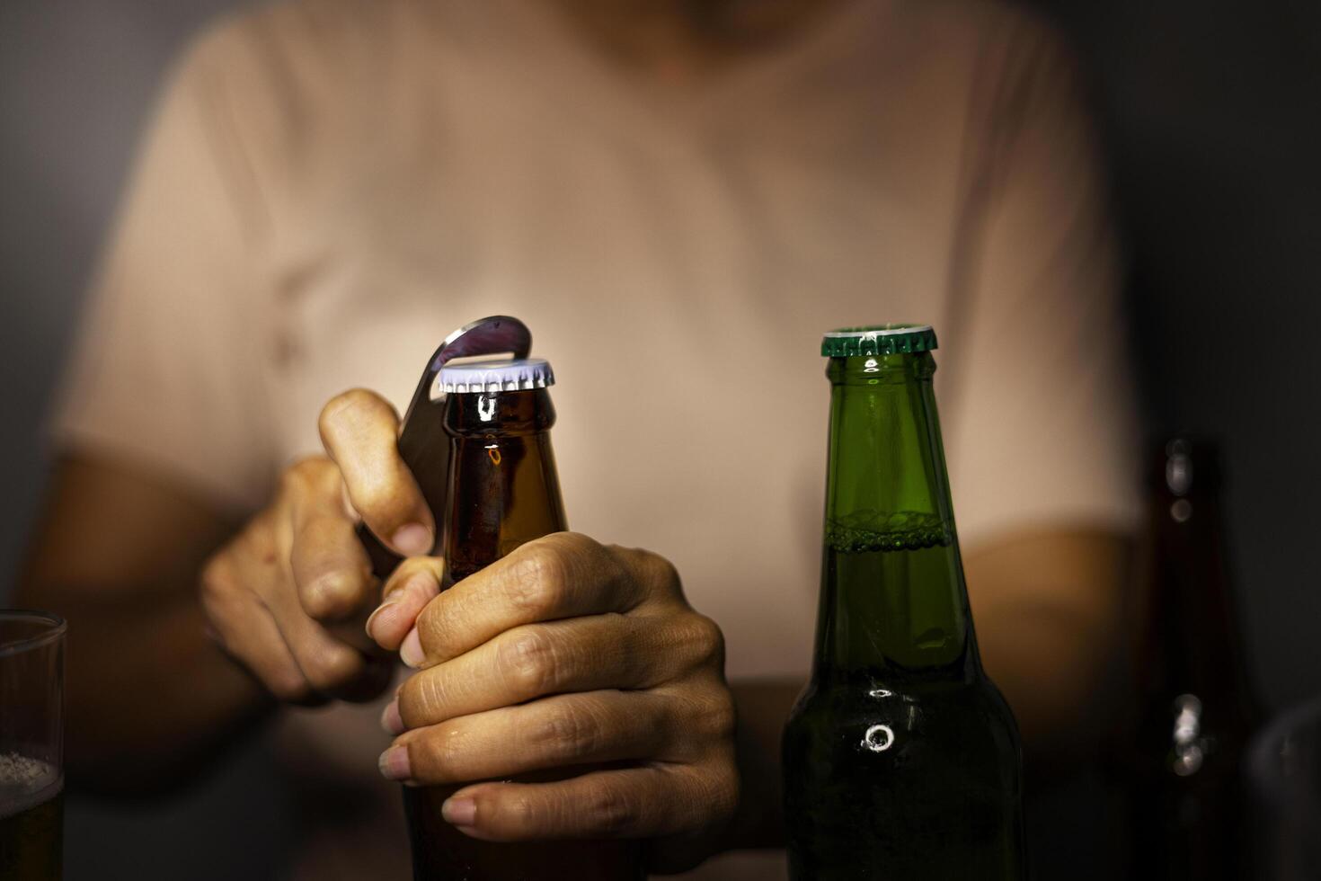 Hands Opening Beer Bottle On The Room Night photo