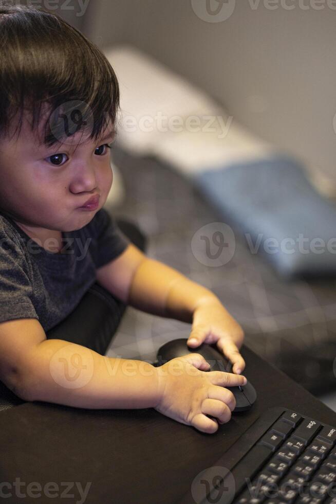 Boy Playing On Computer At Home photo