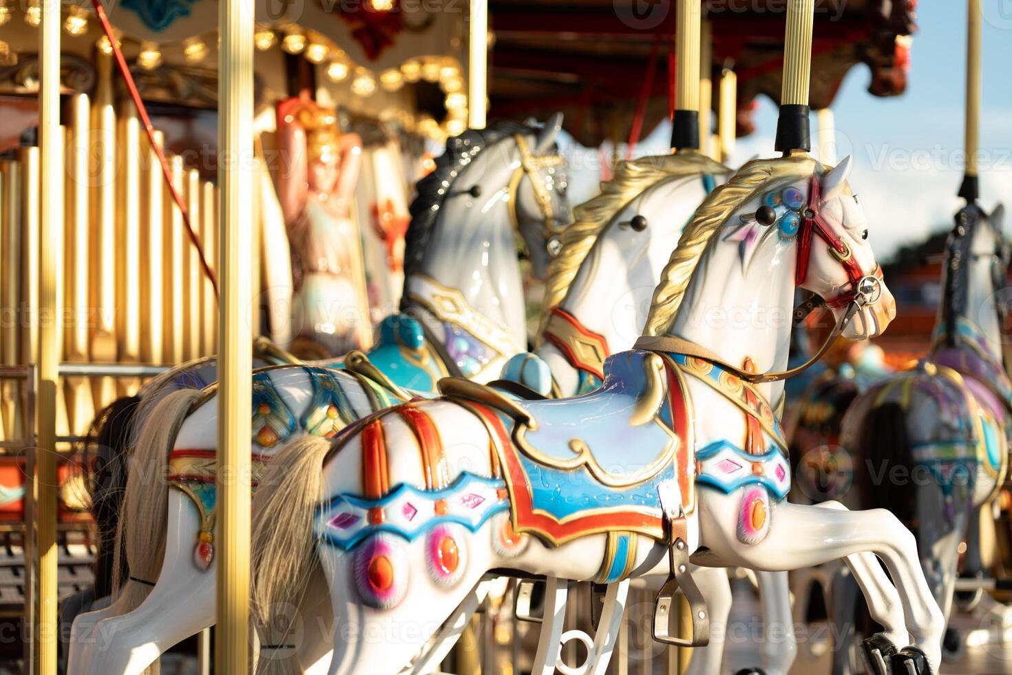 Beautiful vintage fair horse carousel in amusement park photo