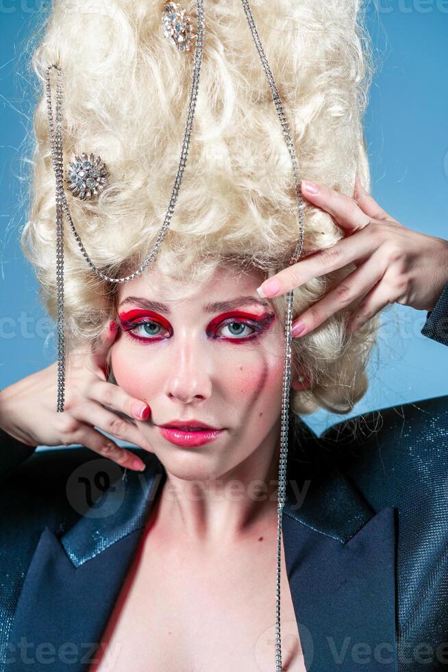 Attractive woman with blond wig and accessories in studio photo