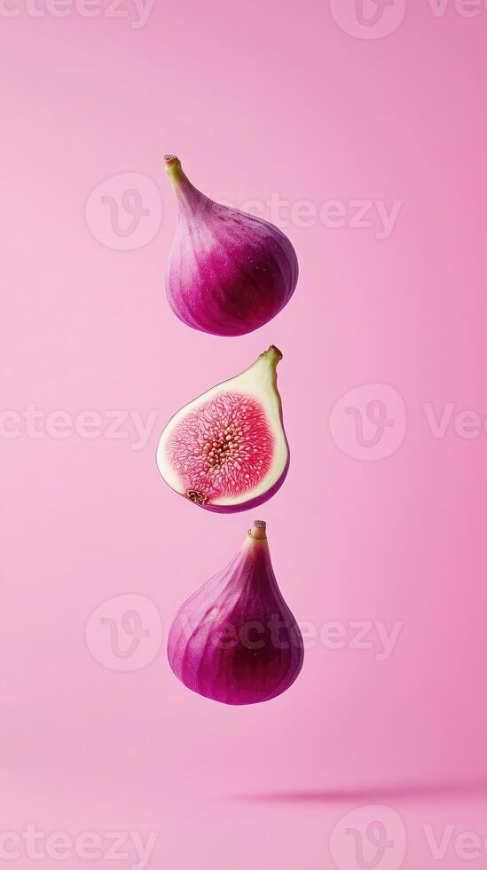 Surreal composition of levitating hot pink figs set against a soft pink backdrop showcasing minimalist design photo
