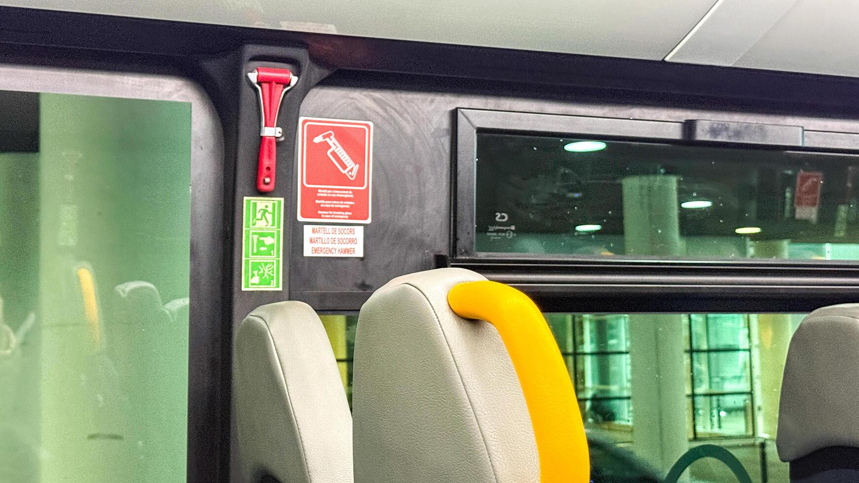 Emergency hammer on bus window, public transportation safety, travel protection, urban transit detail March 16 2025, Barcelona, Spain photo