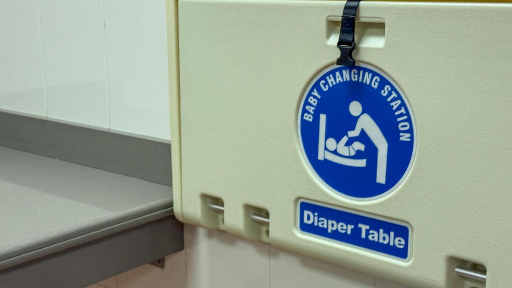 Public baby changing station with sign, family friendly facilities, parenting convenience, infant care essentials March 16 2025, Barcelona, Spain photo