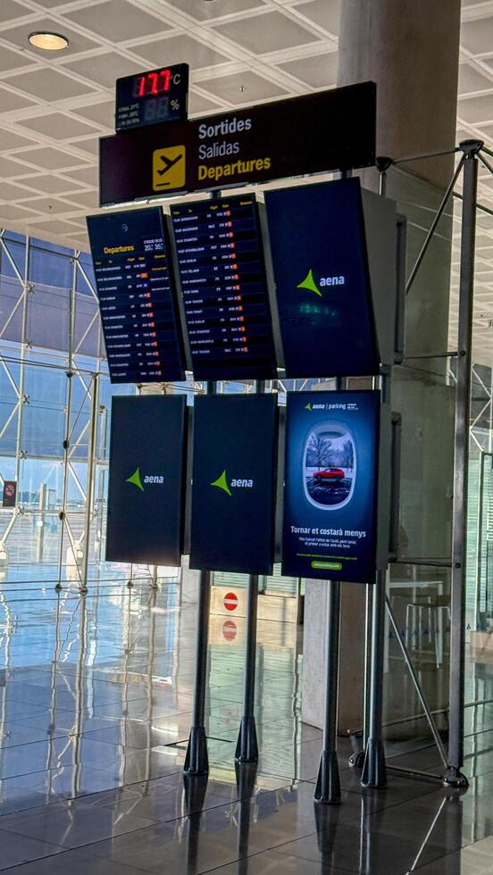 Airport departure display board showing flight information in a modern terminal, travel and aviation concept March 16 2025, Barcelona, Spain photo