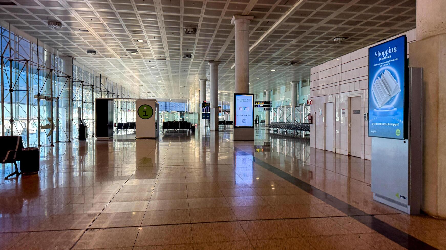 Spacious modern airport terminal interior with high ceilings and advertising screens, travel and transportation March 16 2025, Barcelona, Spain photo