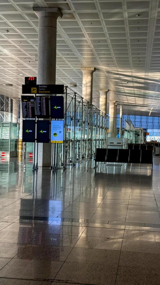 Empty modern airport terminal with flight information displays, travel concept, holiday journey planning March 16 2025, Barcelona, Spain photo