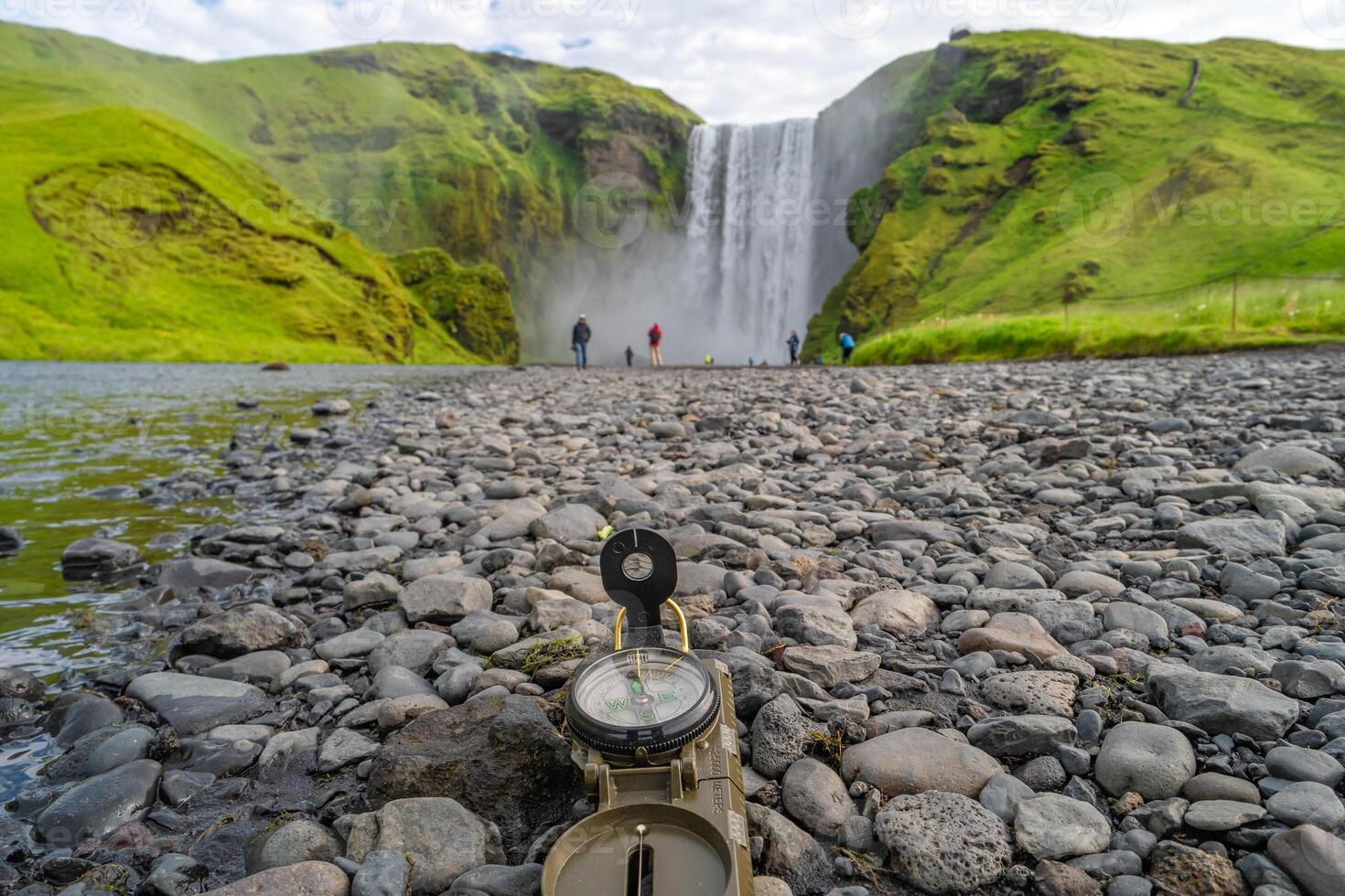 Powerful and famous Skogafoss waterfall and a compass, summer, South Iceland, scenic dramatic view photo