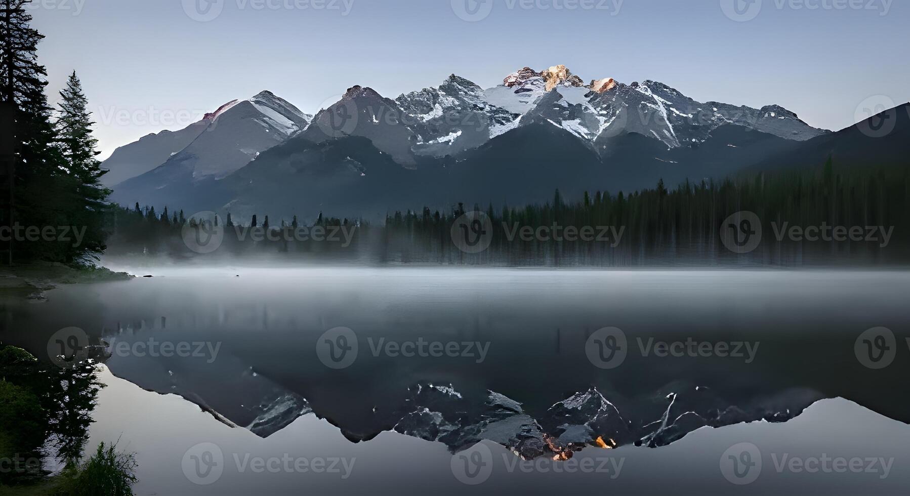 A tranquil mountain lake scene at dawn, capturing the calm water reflecting snow-capped peaks and the soft glow of morning light. Misty Mountain Lake at Sunrise photo