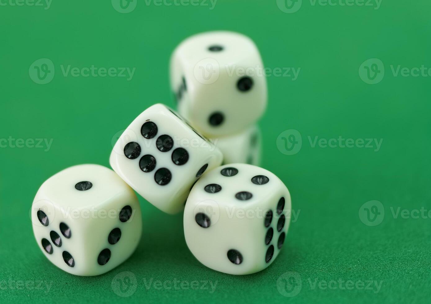 Hand dropping four white dice photo
