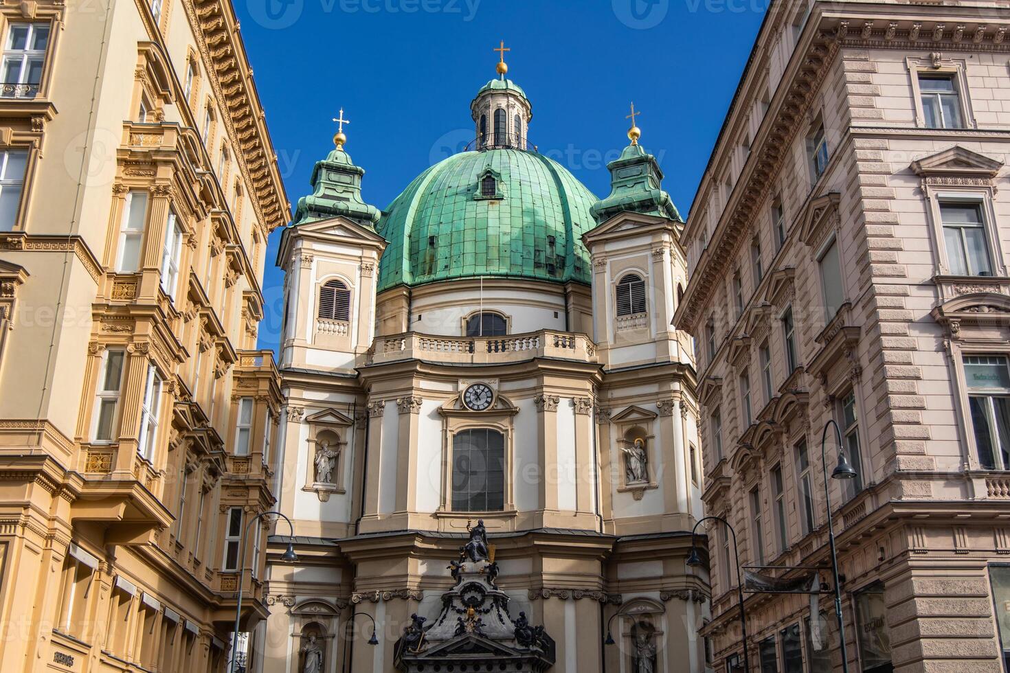 St. Peter's Church rising between buildings in Vienna photo
