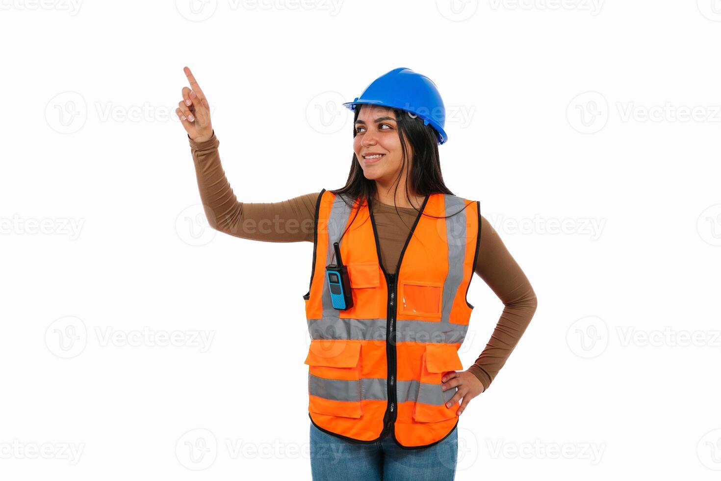 Latina construction worker pointing up with index finger photo
