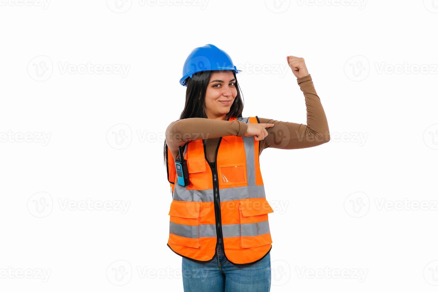 Strong female construction worker flexing biceps and pointing with finger photo