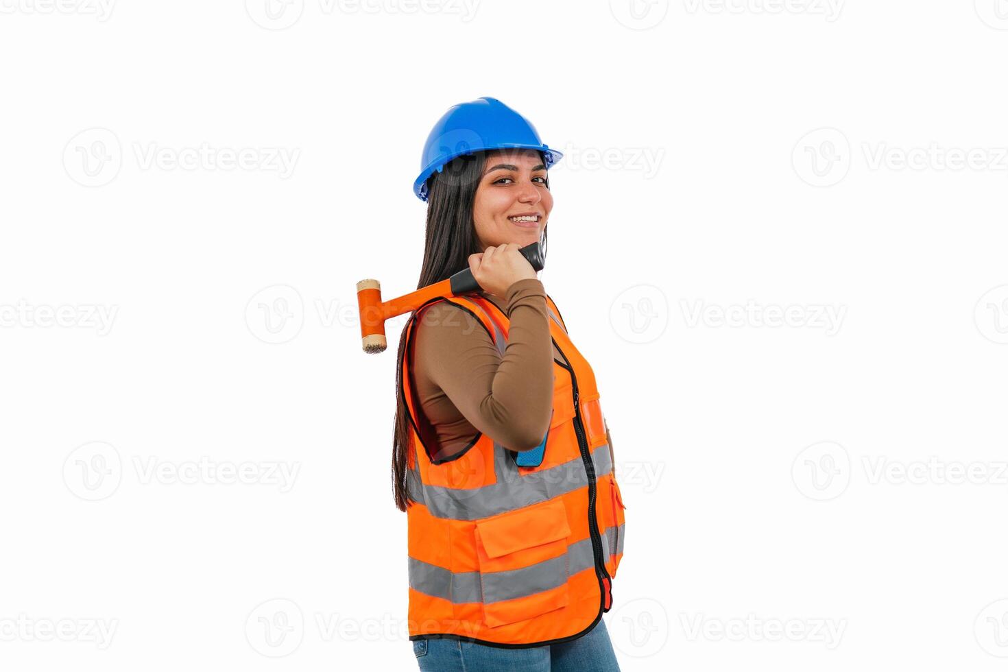 Confident latina construction worker holding hammer on white background photo