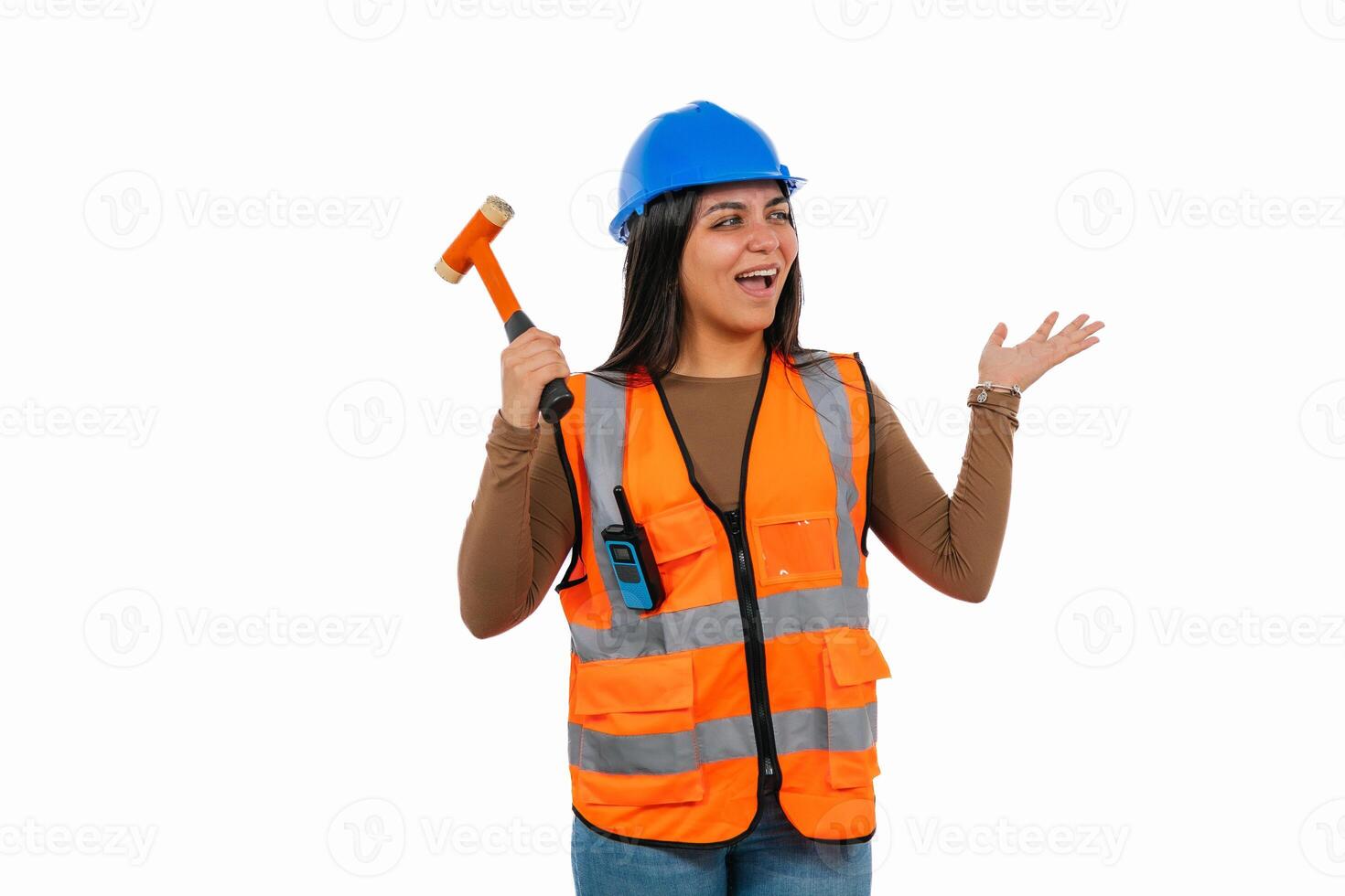 Excited Latina construction worker holding hammer and presenting something photo