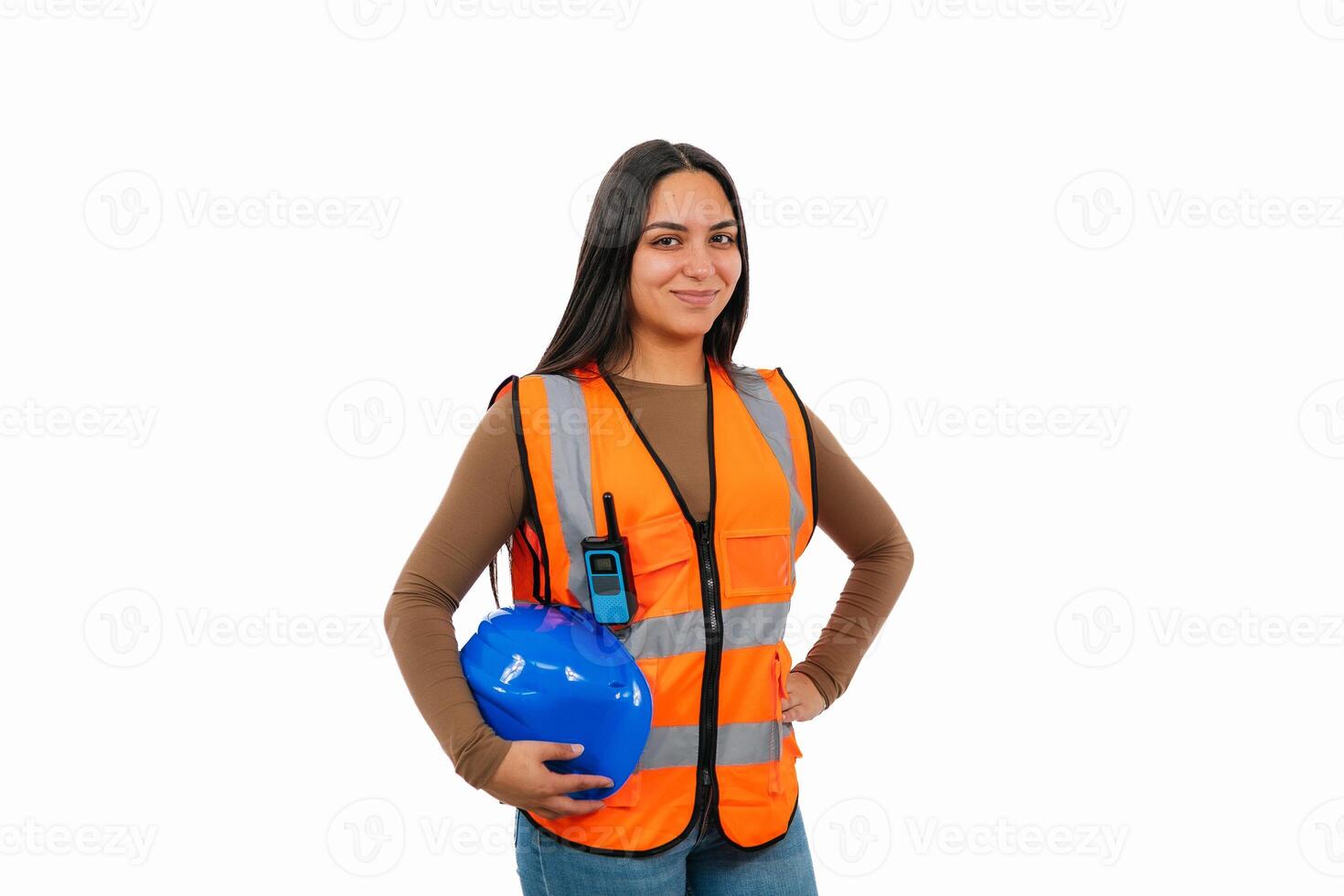 Confident female engineer holding blue helmet and walkie-talkie photo