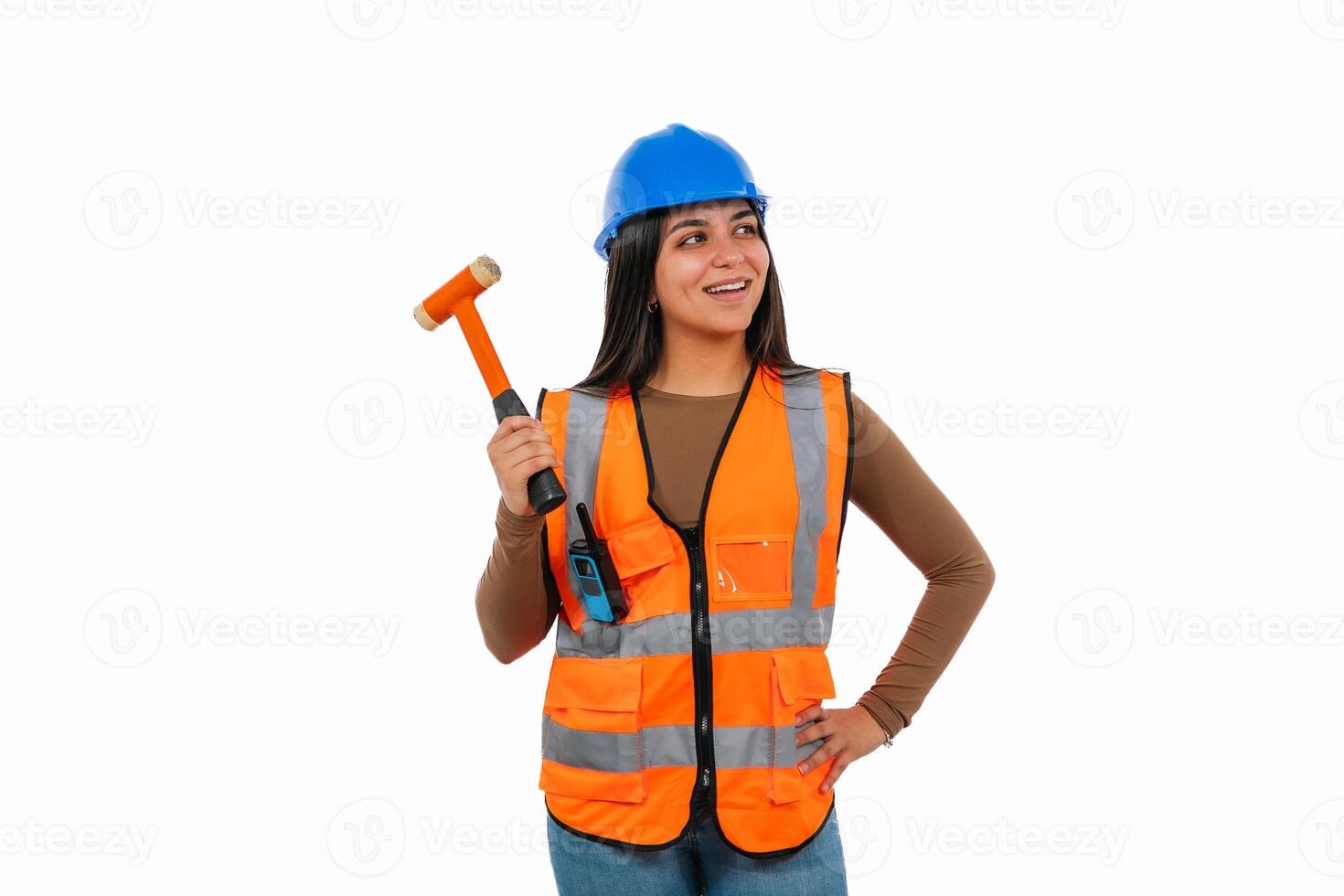 Confident Latin construction worker woman holding hammer and looking away photo