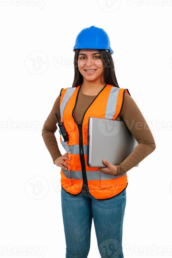 vertical Confident latin architect woman holding laptop and walkie-talkie photo