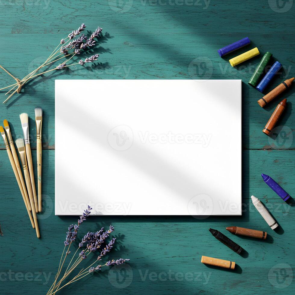 Inspirational flat lay art featuring a white canvas, assorted art supplies, and lavender flowers on a vintage turquoise wood background, perfect for creativity and mockups photo