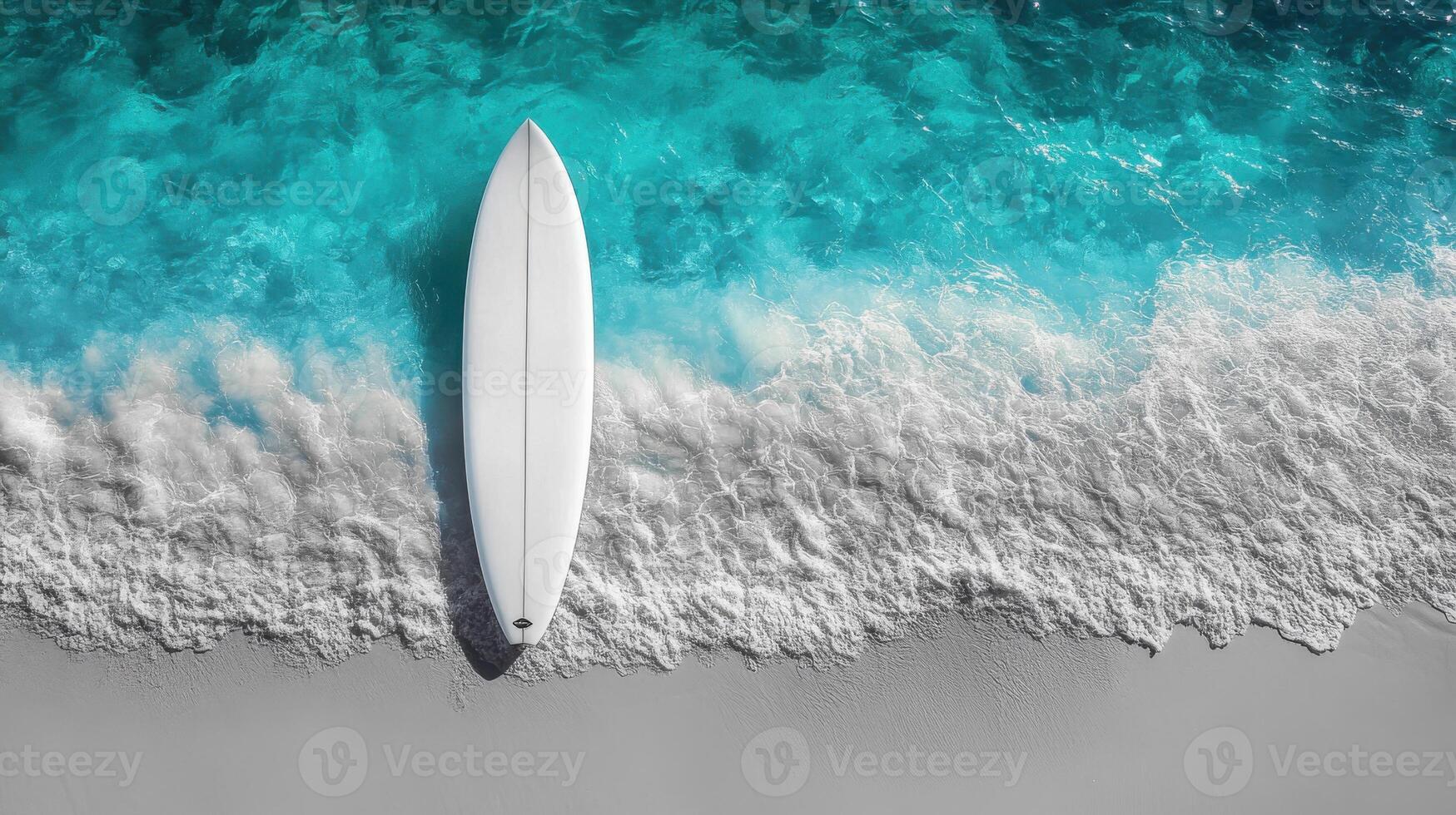 Surfboard Resting on a Sandy Beach with Turquoise Waves photo