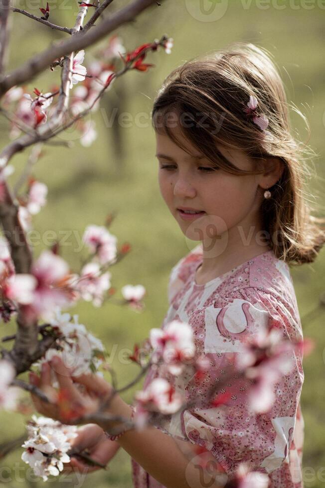 dreamy portrait of a girl in pink surrounded by vibrant pink blossoms, creating a fairytale-like scene photo