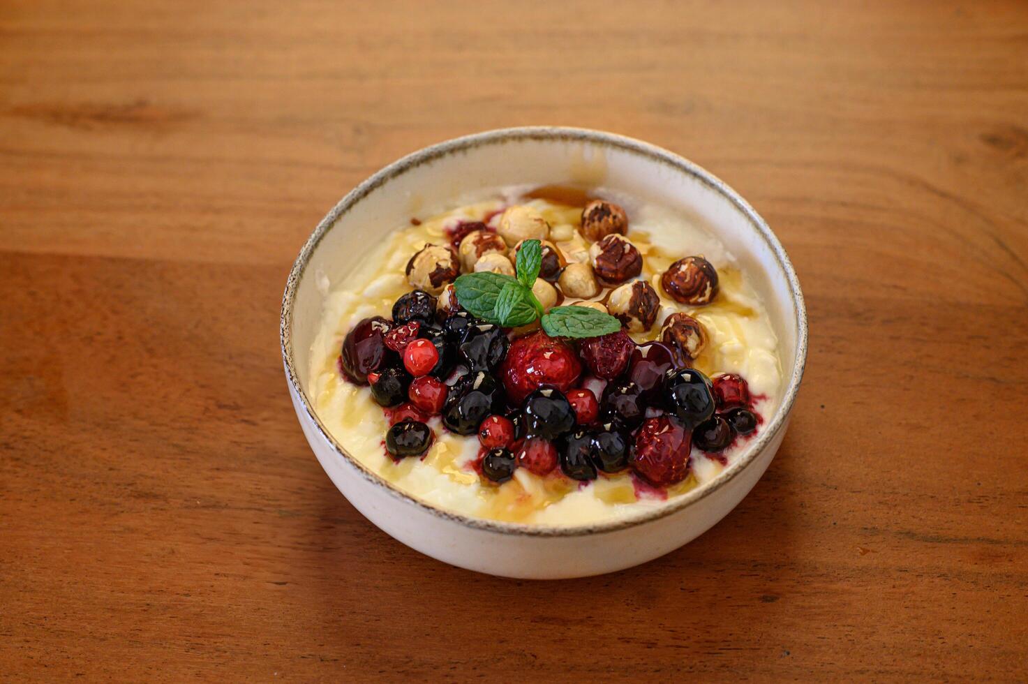 A healthy yogurt bowl with vibrant berries, crunchy nuts, and golden honey for breakfast photo