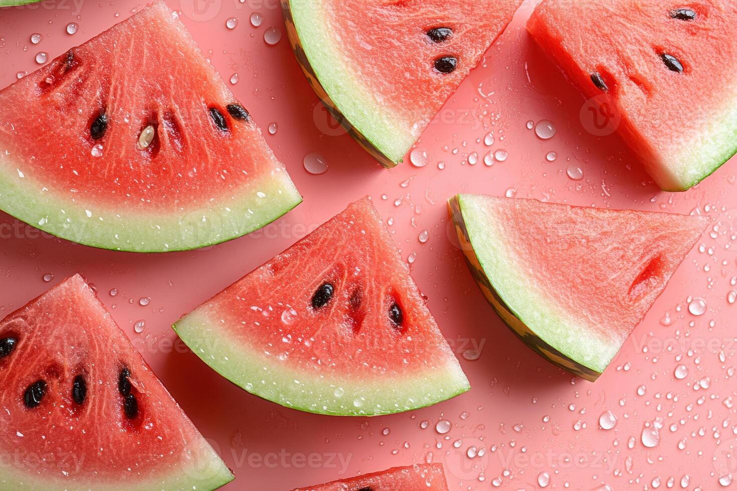 Fresh watermelon slices arranged on pink background creating seamless summer pattern photo