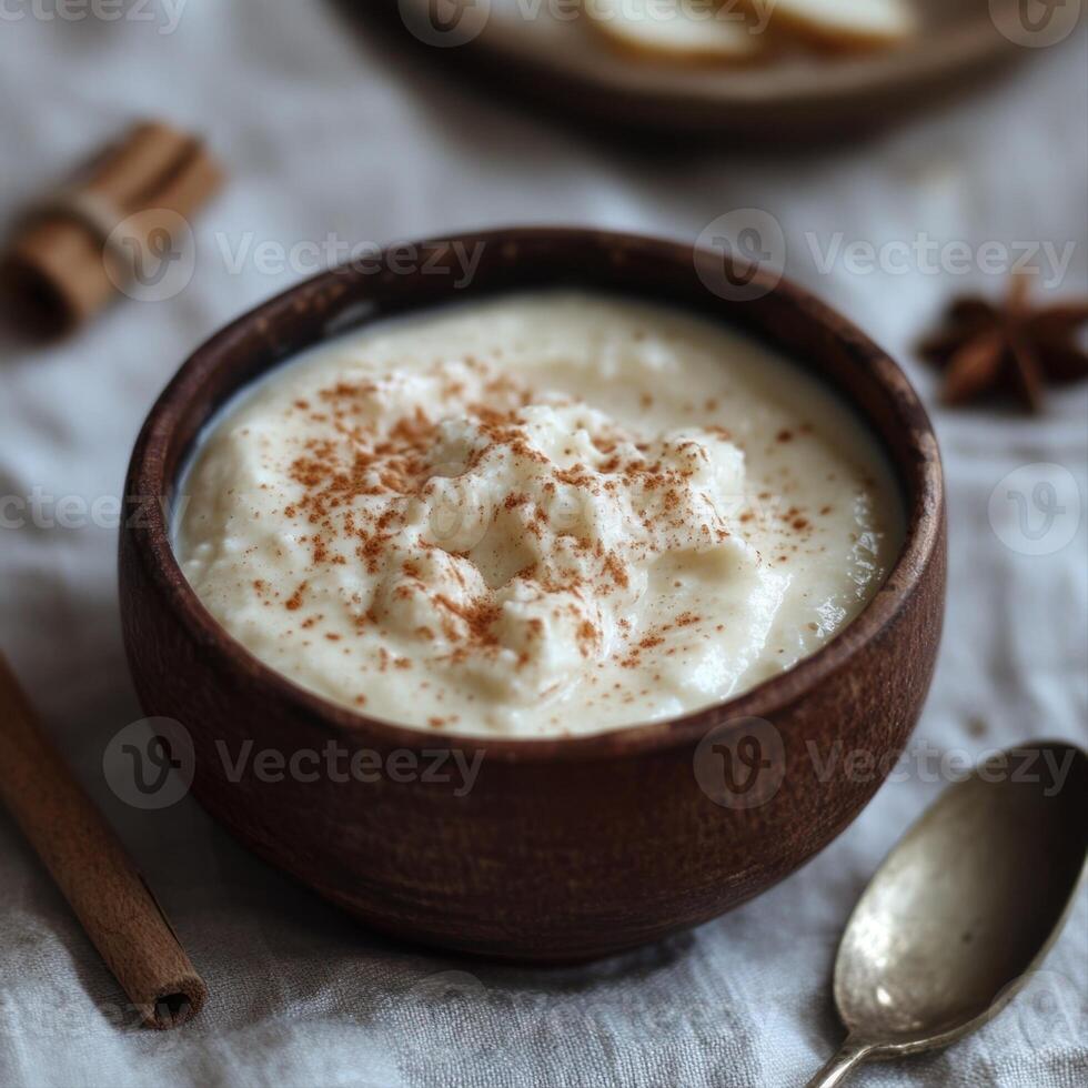 Delicious rice pudding with cinnamon in wooden bowl photo