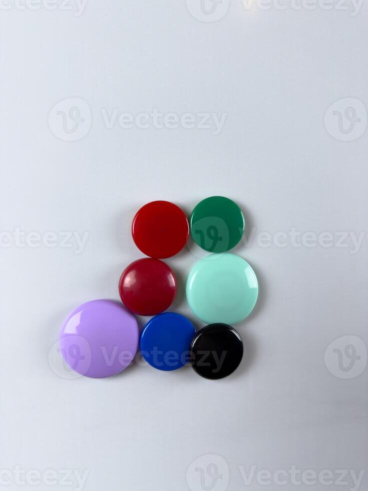 Group of magnets on whiteboard perfect for securing notes and reminders ideal for creating efficient task management systems in various settings photo