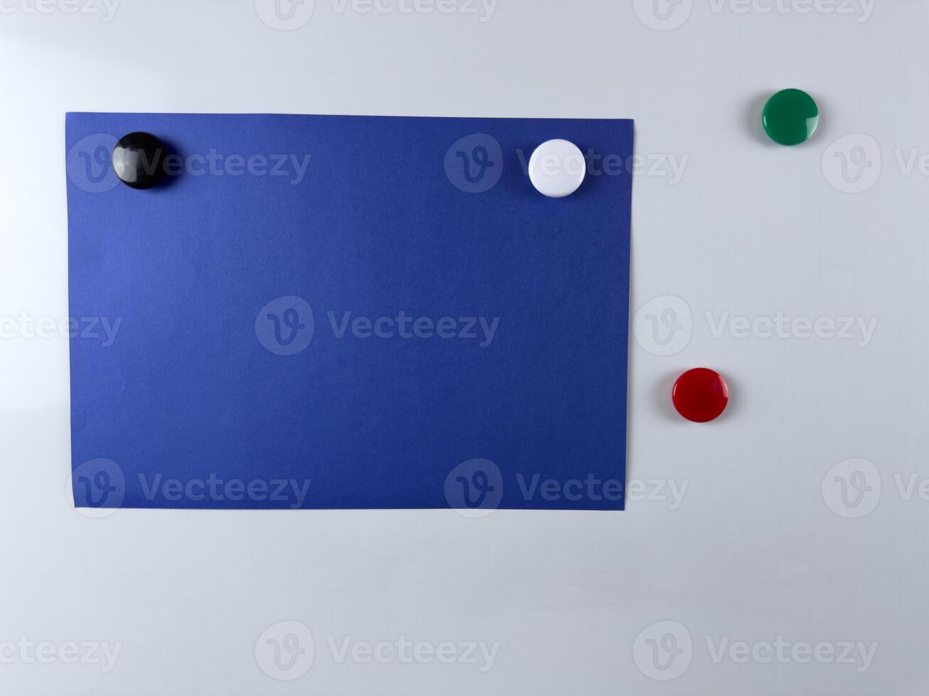 Blue note paper attached to whiteboard with colorful magnets perfect for reminders presentations and creative workspaces useful in both office and educational settings photo