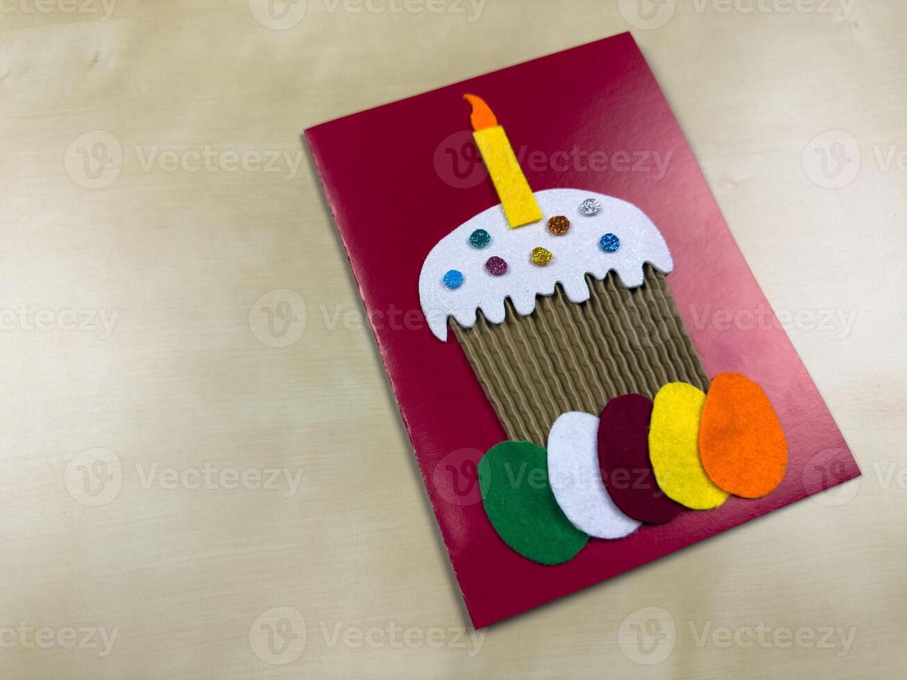 This charming card features felt applique of cake with candle and colorful eggs. Perfect for Easter greetings or birthday wishes, it adds personal touch to your celebrations photo