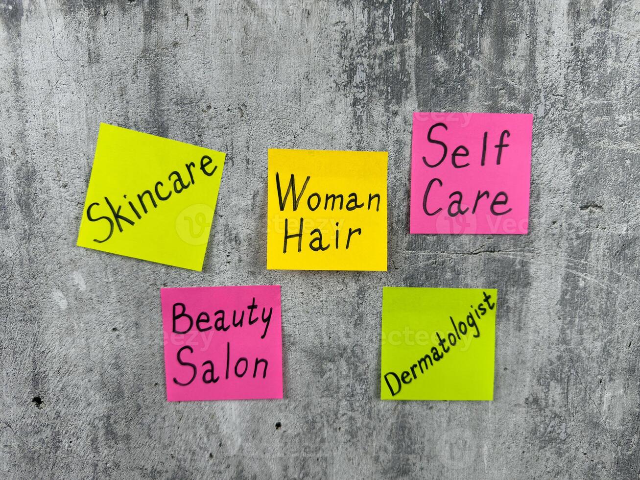 Multicolored stickers with conceptual idea about woman hair. The importance of selfcare and going to beauty salon to take care of your skin and hair. Reminder about woman selfcare routine photo