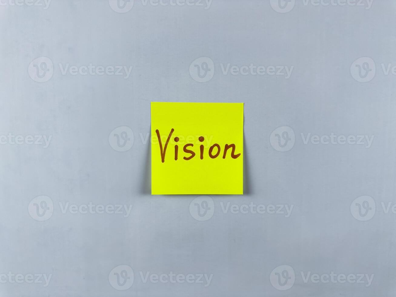 Sticky note with the word Vision written on it, pinned on white background. Photo symbolizes foresight, goals, and inspiration. Perfect for illustrating concepts of vision and future aspirations