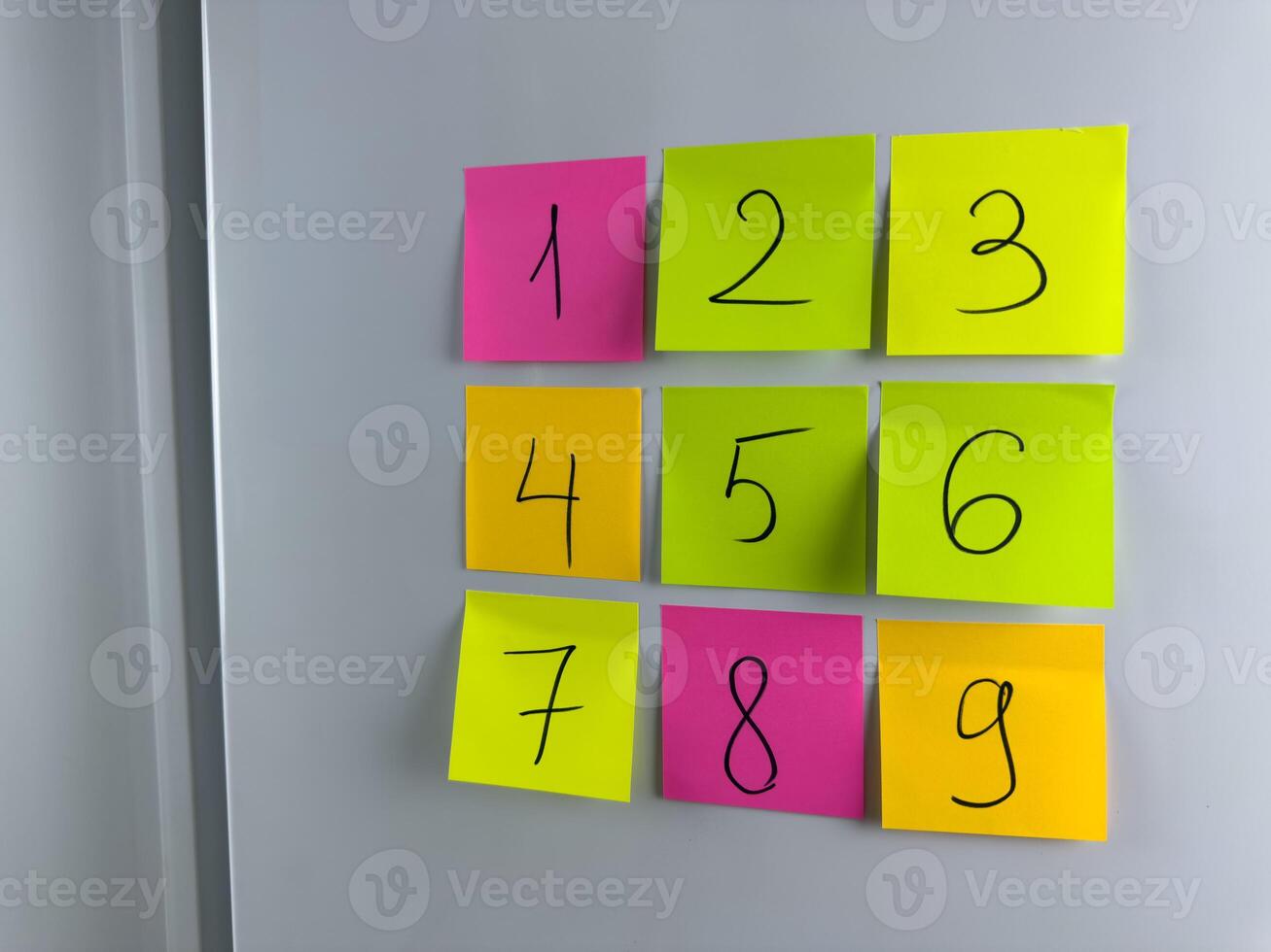 Card with written numbers on refrigerator at home for study children photo