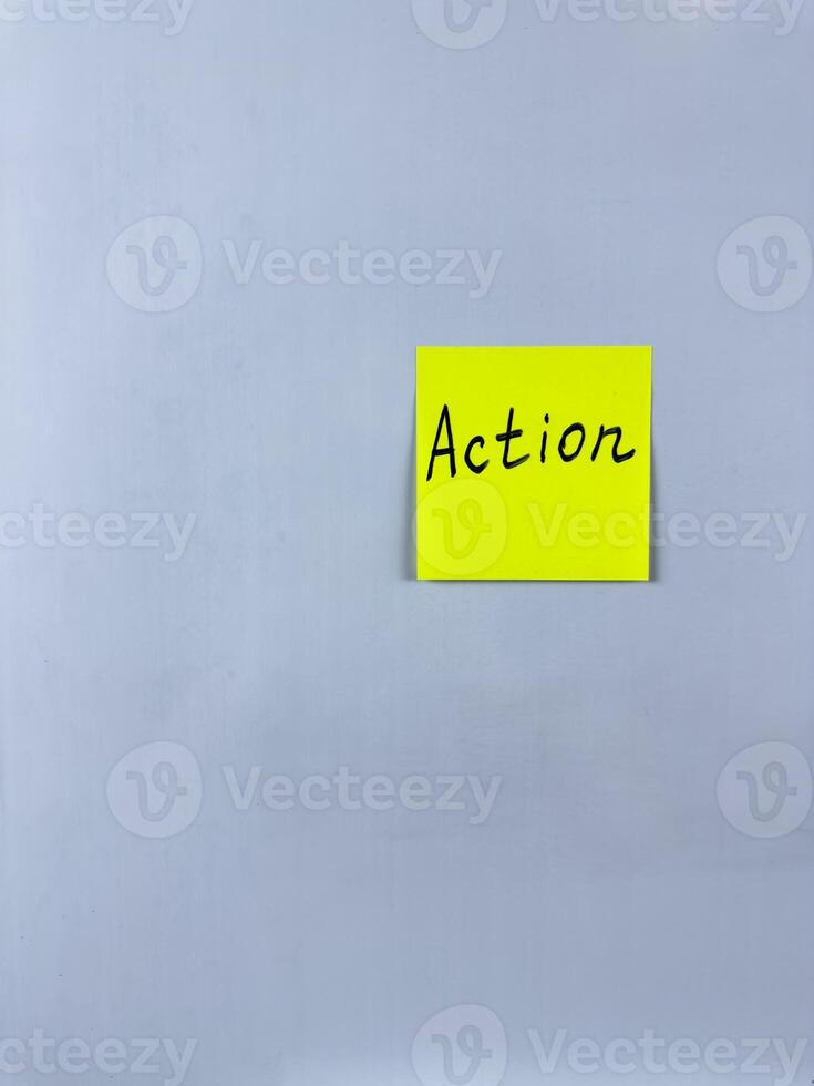 Sticky note with Action written on it, affixed to white background. This image represents initiative and productivity, ideal for themes of taking action and making progress photo