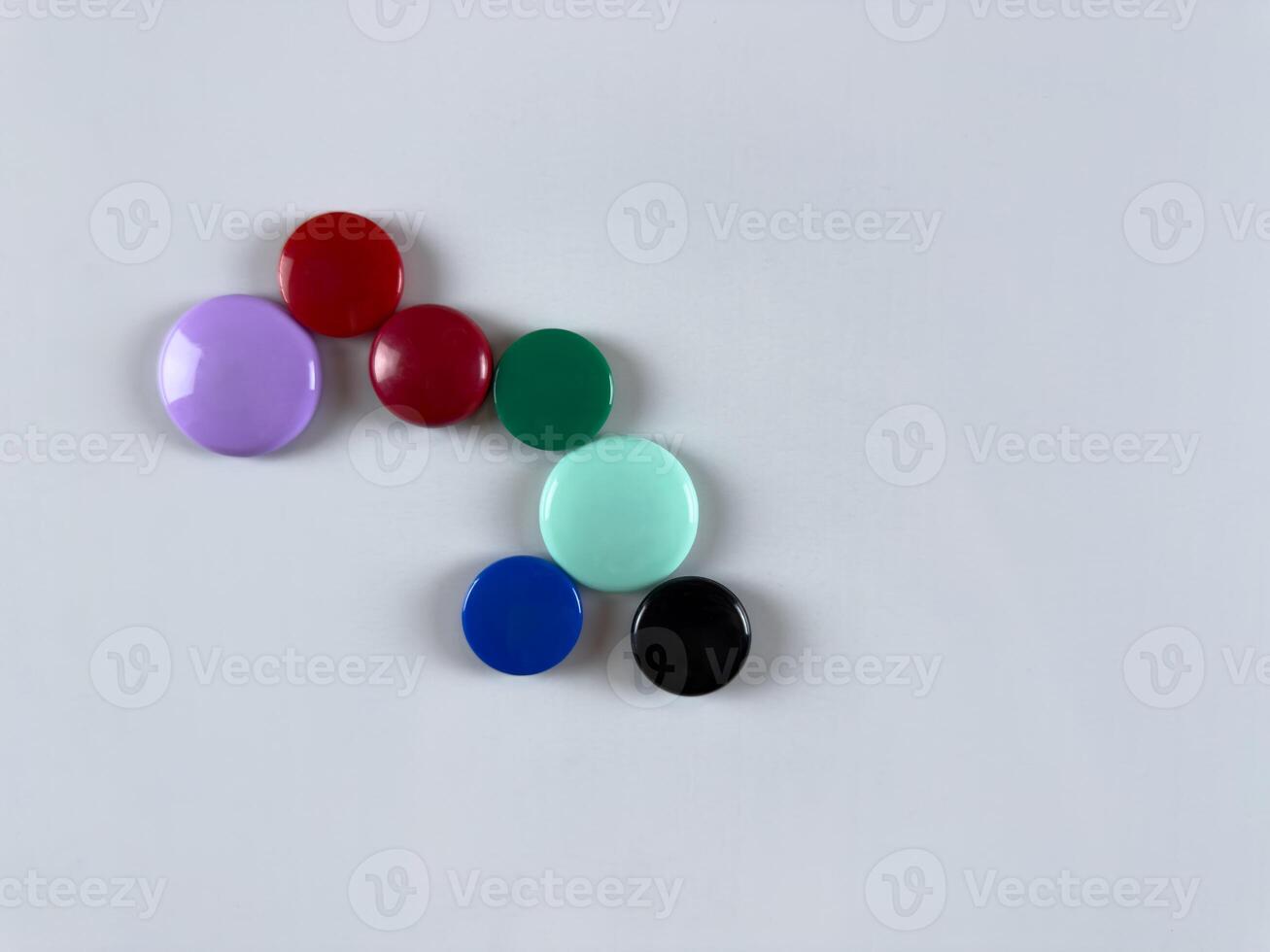 Whiteboard with scattered magnets great for organizing notes and tasks in office and school. Enhancing productivity and providing flexible workspace setup. Organization of personal time photo