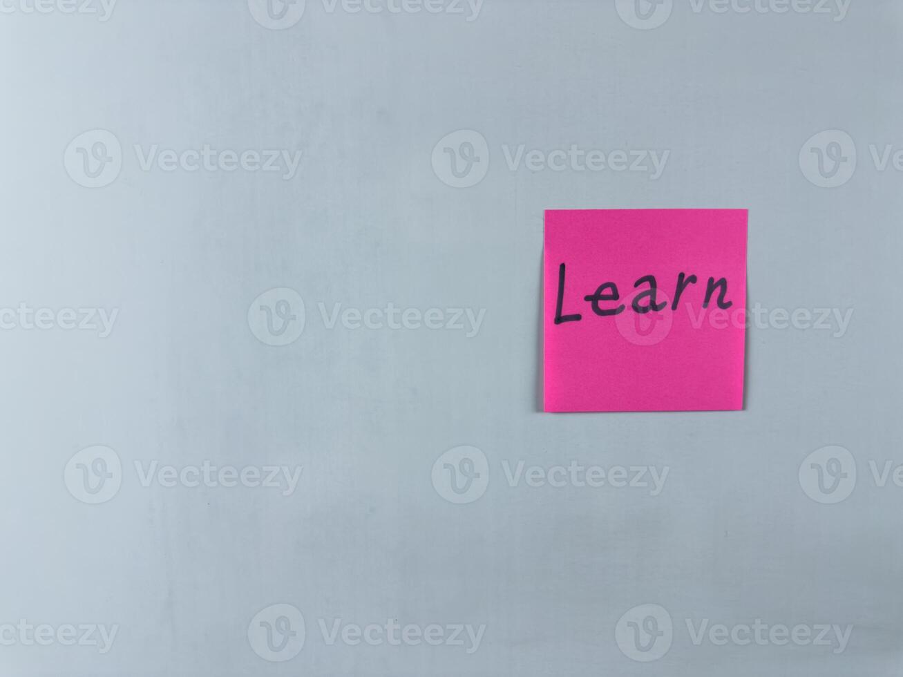 Sticky note with the word Learn written on it, placed on white background. Ideal for illustrating themes of education, knowledge, and personal growth. Great for concept creation photo